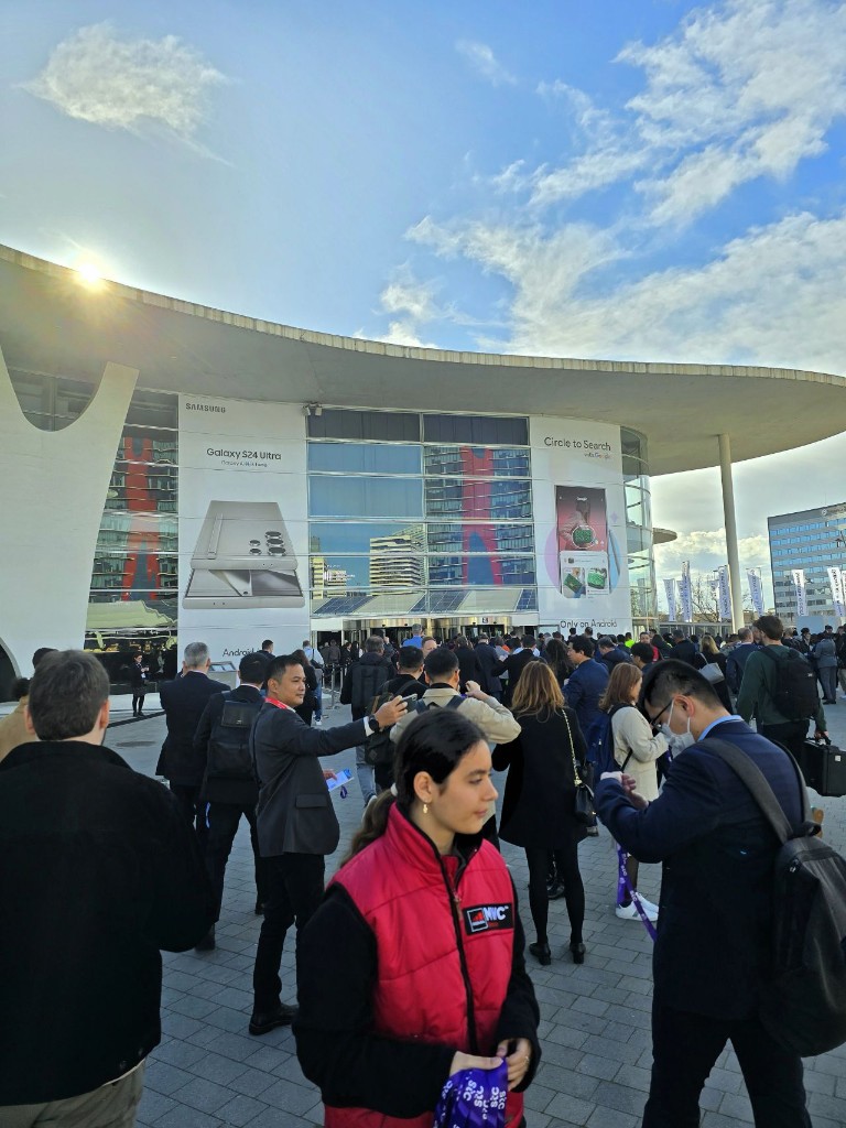 Crowd of attendees outside the MWC 2024 entrance at Fira Barcelona Gran Via