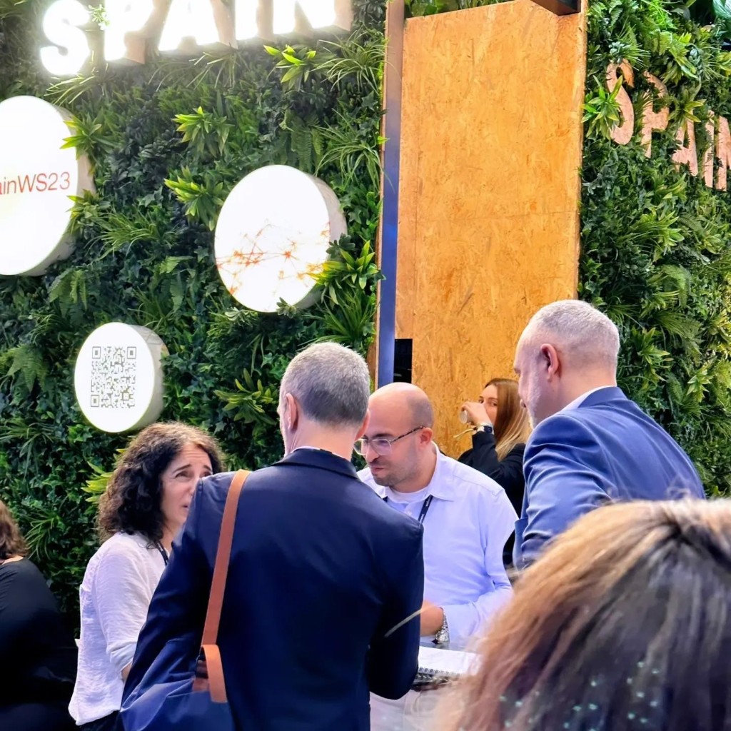 Conversations at the Spain Pavilion green-wall stand during Web Summit 2023 in Lisbon